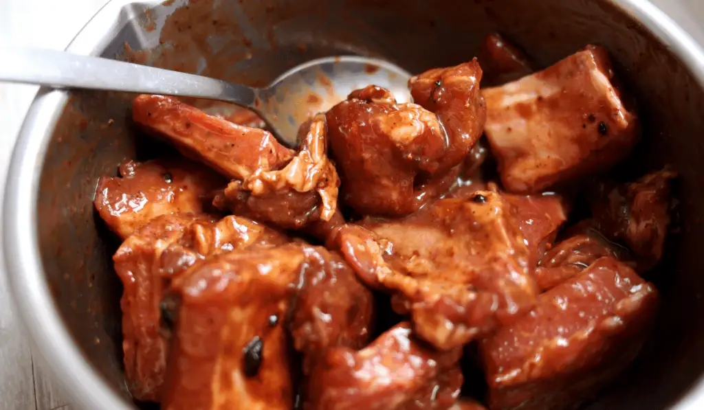 Juicy meat slices being generously coated with Honey Soy Sauce Marinade for enhanced flavor.
